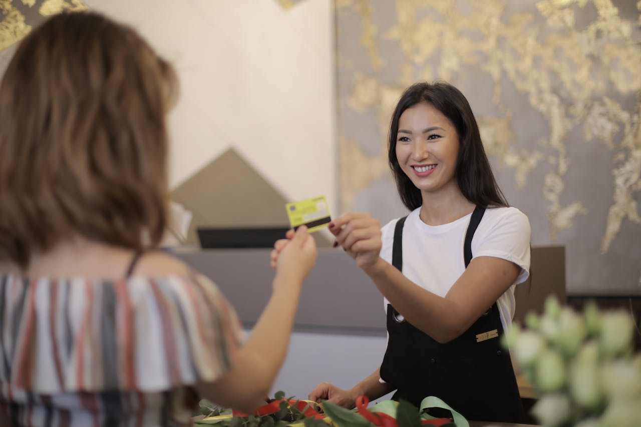 Small business owner using a POS system to process customer purchases